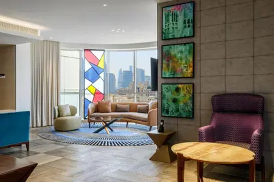 a living room with a couch and a chair at Andaz Family Suites by Hyatt- Palm Jumeirah in Dubai