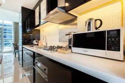 a kitchen with a microwave on a counter at Staycae Bay's Edge in Dubai