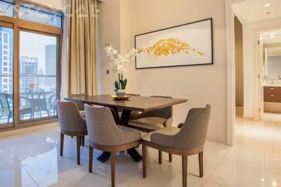 a dining room with a table and chairs at Staycae Avanti in Dubai