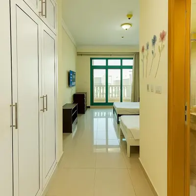 a hospital room with two beds and a hallway at Masters and Double Rooms For Girls ONLY in Marina, Dubai in Dubai