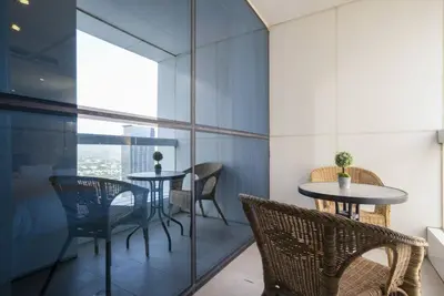 a dining room with two tables and chairs at GuestReady - Modern Studio | Stunning Marina Views in Dubai