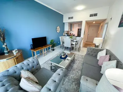 a living room with a couch and a table at Luton Vacation Homes -sea view -Damac Heights, Dubai Marina -90AB2 in Dubai
