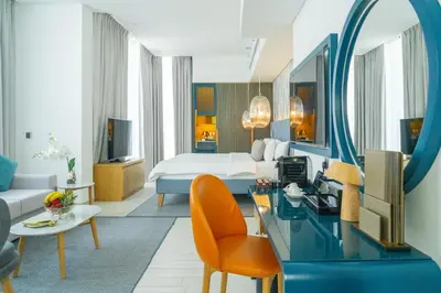 a hotel room with a bed and a mirror at C Central Hotel and Resort The Palm in Dubai