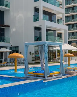 a swimming pool with umbrellas and a hotel at C Central Hotel and Resort The Palm in Dubai