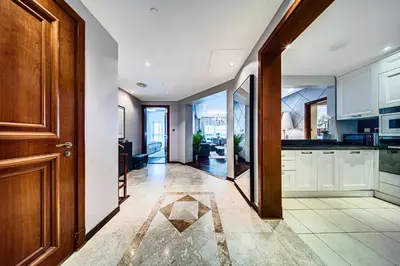 a kitchen with white cabinets and a wooden door at Nice 2BD apartment in the Palm Jumeirah in Dubai