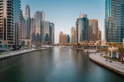 a river in the middle of a city with tall buildings at Crowne Plaza Dubai Marina by IHG in Dubai