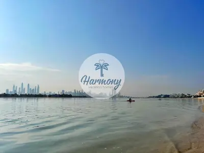a sign on the water with the city in the background at Harmony Vacation Homes - BALQIS Residence in Dubai