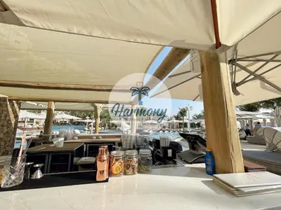 a table with a view of a restaurant with a view of the water at Harmony Vacation Homes - BALQIS Residence in Dubai
