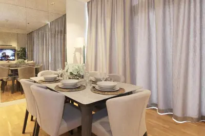 a dining room with a table with white chairs at New Arabian Luxury 2 Bedroom In Blue Water in Dubai