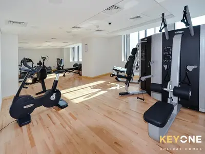 a gym with treadmills and cardio equipment in a room at Sophisticated One Bedroom with Full Marina View in Dubai
