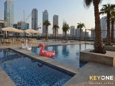 a swimming pool with two plastic swans in a city at Sophisticated One Bedroom with Full Marina View in Dubai
