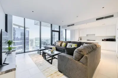 a living room with a couch and a table at Maison Privee - Luxury, Spacious, Modern Near Burj Khalifa and Dubai Canal in Dubai