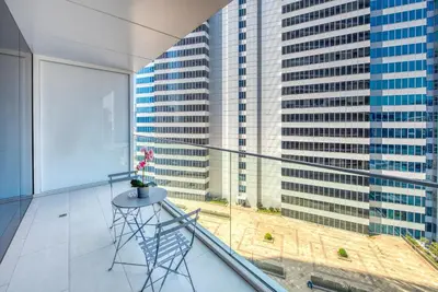 a balcony with a table and a view of a city at Maison Privee - Luxury, Spacious, Modern Near Burj Khalifa and Dubai Canal in Dubai