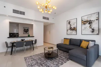 a living room with a couch and a table at Silverene Towers Dubai Marina - By Home Of Choice in Dubai