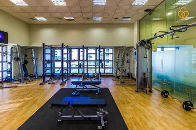 a gym with several treadmills and machines in it at Princess Tower highest world Penthouse floor 86! in Dubai