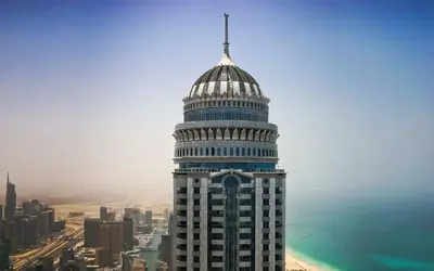 a tall building with a dome on top of it at Princess Tower highest world Penthouse floor 86! in Dubai