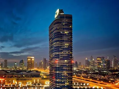 a tall building in a city at night at HotelApart Dubai Mall st Burj Khalifa View in Dubai