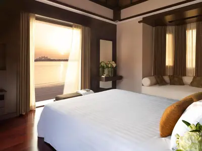 a bedroom with a large bed and a large window at Anantara The Palm Dubai Resort in Dubai