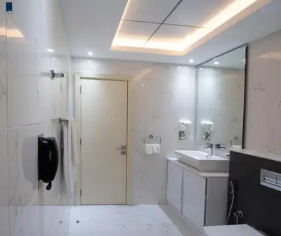 a bathroom with a shower and a sink and a mirror at Samaya Hotel Apartment Dubai in Dubai
