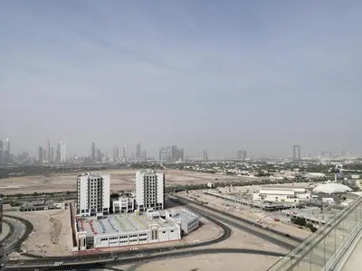 an aerial view of a city with tall buildings at Cozy 1BR Apart With Pool And Gym 10mins Away By drive to DXB Airport in Dubai