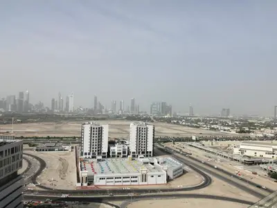 an aerial view of a city with tall buildings at Cozy 1BR Apart With Pool And Gym 10mins Away By drive to DXB Airport in Dubai
