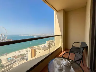 a balcony with a table and a view of the ocean at HiGuests - Amazing Sea Views from this 2BR Apt in JBR in Dubai