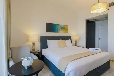 a bedroom with a large bed and a table at HiGuests - Amazing Sea Views from this 2BR Apt in JBR in Dubai