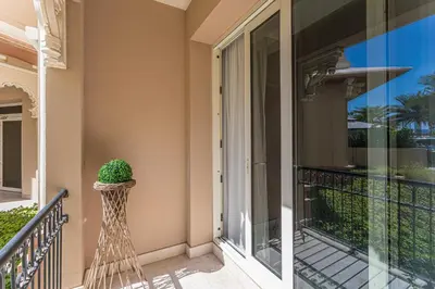a plant on the balcony of a house at HiGuests - Luxurious 1BR in Palms with Private Beach Access in Dubai