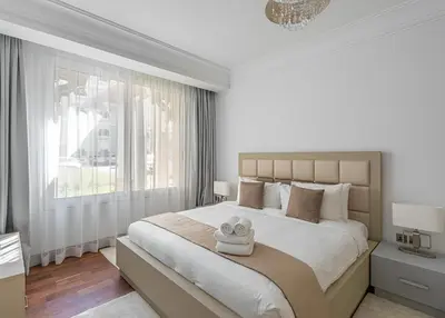 a bedroom with a large bed with two towels on it at HiGuests - Luxurious 1BR in Palms with Private Beach Access in Dubai
