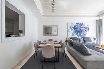a living room with a table and a couch at HiGuests - Luxurious 1BR in Palms with Private Beach Access in Dubai