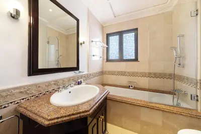 a bathroom with a sink and a tub and a mirror at Maison Privee - 5 Stars Villa with Private Pool or Beach on Palm Jumeirah in Dubai