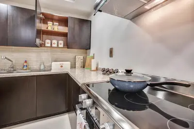 a kitchen with a stove with a bowl on it at Luxury Apartments at Balqis Residence in Dubai