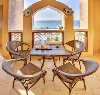 a dining room with a table and chairs and a window at Luxury Apartments at Balqis Residence in Dubai