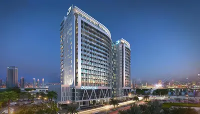 a tall building with a sign on the side of it at Staycae Holiday Homes - Majestine in Dubai