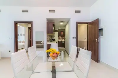 a dining room with a glass table with a bowl of fruit at Holiday Apartment in Palm Jumeirah with Beach Access in Dubai