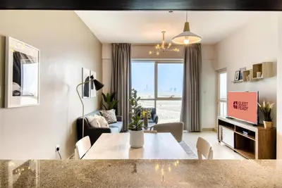 a living room with a dining table and a living room at GuestReady Holiday Homes - Sunny Delights in Dubai