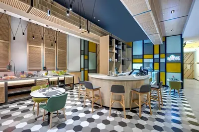 a kitchen with a table and chairs and a counter at URBAN Al Khoory Hotel in Dubai
