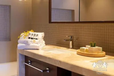 a bathroom with a sink with towels and a mirror at Westminster Boulevard Point in Dubai