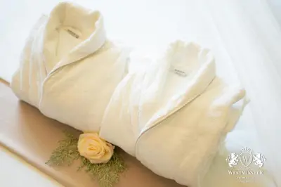 two white towels with flowers on a table at Westminster Boulevard Point in Dubai