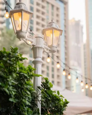 a light pole with lights on it in a city at Westminster Boulevard Central - Burj Khalifa in Dubai