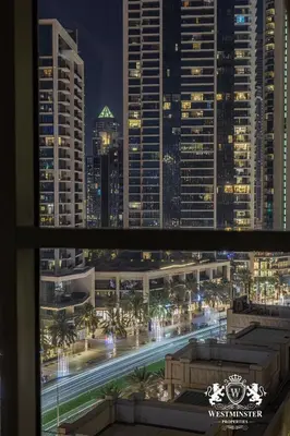 a view from a window of a city at night at Westminster Boulevard Central - Burj Khalifa in Dubai