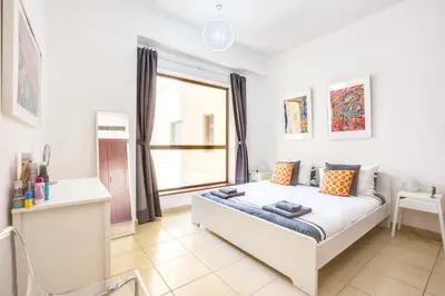 a bedroom with a large white bed with a window at 1 Bedroom with Stunning Ain Dubai and Full Sea View in Dubai