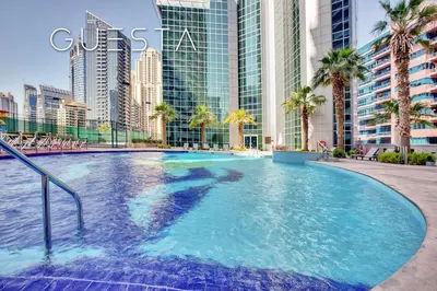 a large swimming pool in the middle of a city at The Waves by DAMAC, Dubai Marina in Dubai