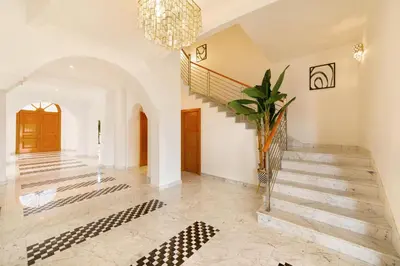 a large hallway with stairs and a chandelier at Maison Privee - Luxury Villa with Dramatic View Private Beach & Pool in Dubai