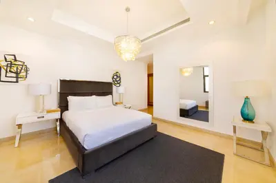 a bedroom with a large bed and a mirror at Maison Privee - Luxury Villa with Dramatic View Private Beach & Pool in Dubai