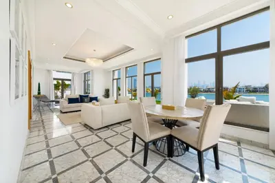 a living room with a table and chairs at Maison Privee - Luxury Villa with Dramatic View Private Beach & Pool in Dubai