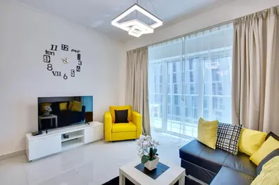 a living room with a couch and a tv at Ultra modern 1BD in Damac Heights Marina in Dubai