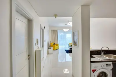 a kitchen with a washer and dryer in a room at Ultra modern 1BD in Damac Heights Marina in Dubai