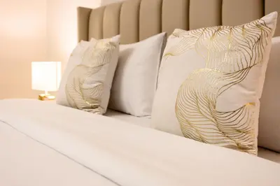 a bed with white pillows and a lamp on it at Wonderful 2BD apartment near The Beach Sadaf JBR in Dubai