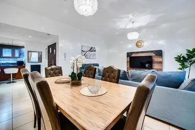 a dining room with a table and a blue couch at Wonderful 2BD apartment near The Beach Sadaf JBR in Dubai